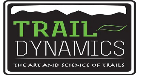 A black and white logo for trail dynamics.
